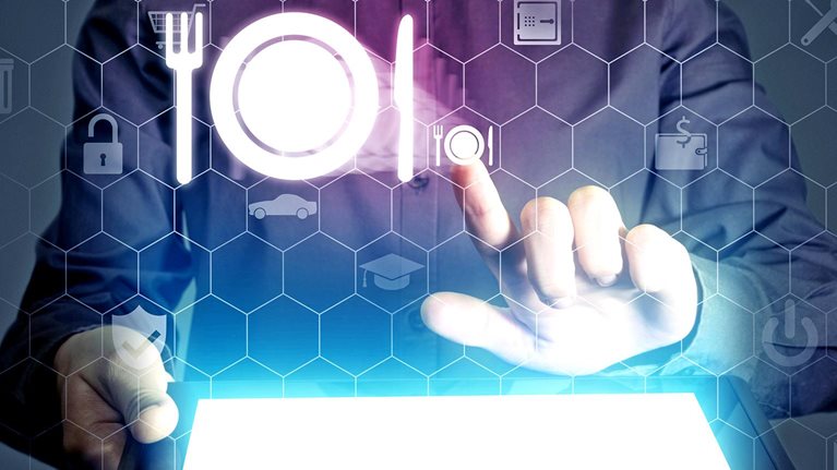 Conceptual close up image of a fine dining waitress placing an order using hologram icons.