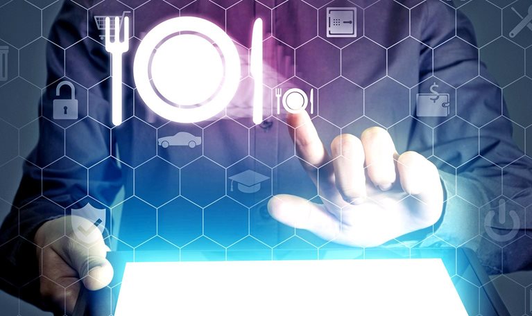 Conceptual close up image of a fine dining waitress placing an order using hologram icons.