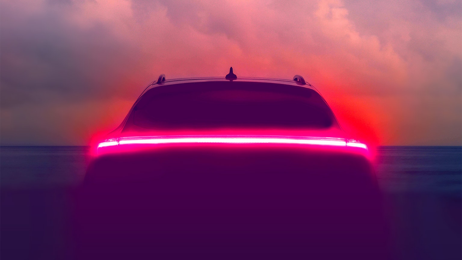 Brake lights glowing on an autonomous vehicle with a hazy blue sky in the background