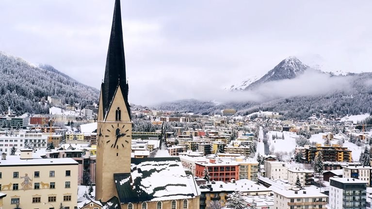 Video still of buildings with mountains