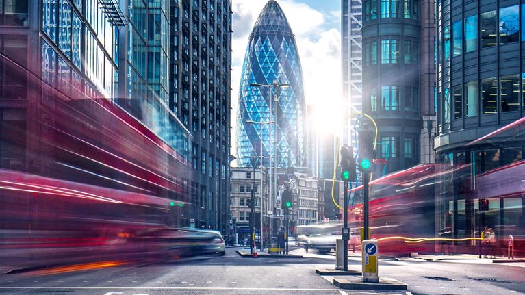 Buses on the street at the financial district of London.