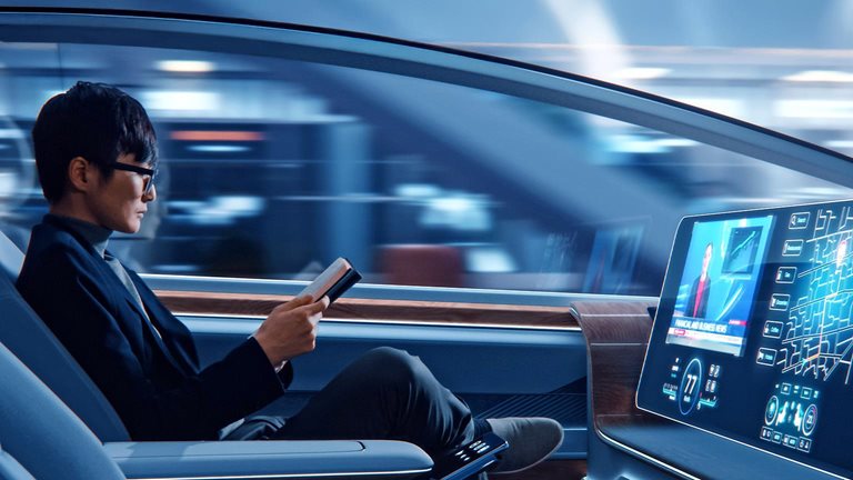 Futuristic Concept: Handsome Stylish Japanese Businessman in Glasses Reading Notebook and Watching News on Augmented Reality Screen while Sitting in a Autonomous Self-Driving Zero-Emissions Car.