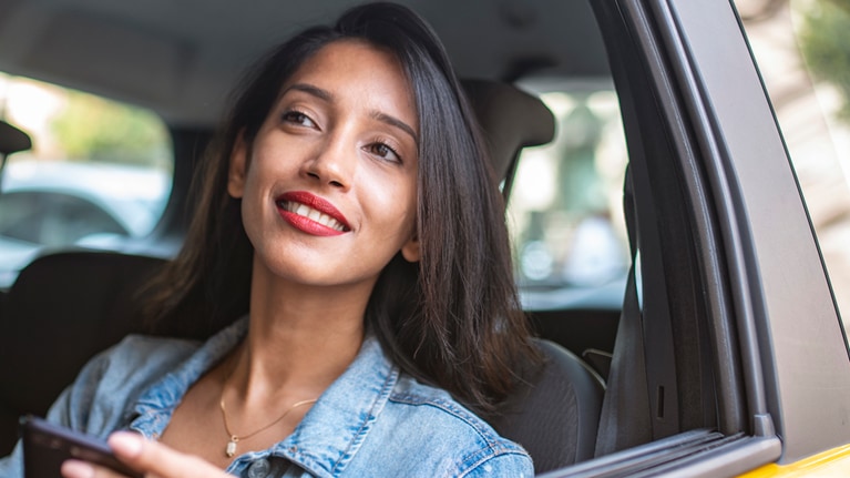 Image of woman looking outside of a car window