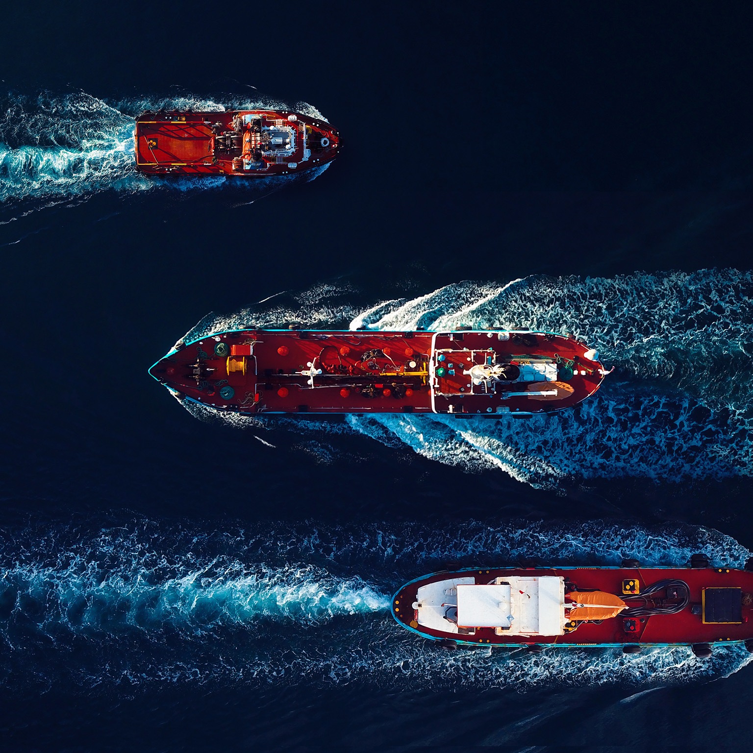 Aerial view of Oil and Gas tanker ships on the move in the harbour. - stock photo