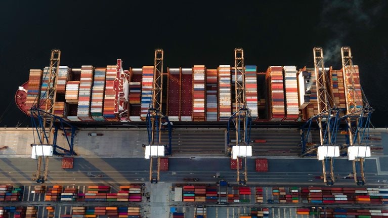 The largest TEU top 5 of the world container vessel in the condition of alongside the terminal jetty wharf of the port, load and discharging units of container shipment in port yard for transport services to Worldwide under logistics system networks