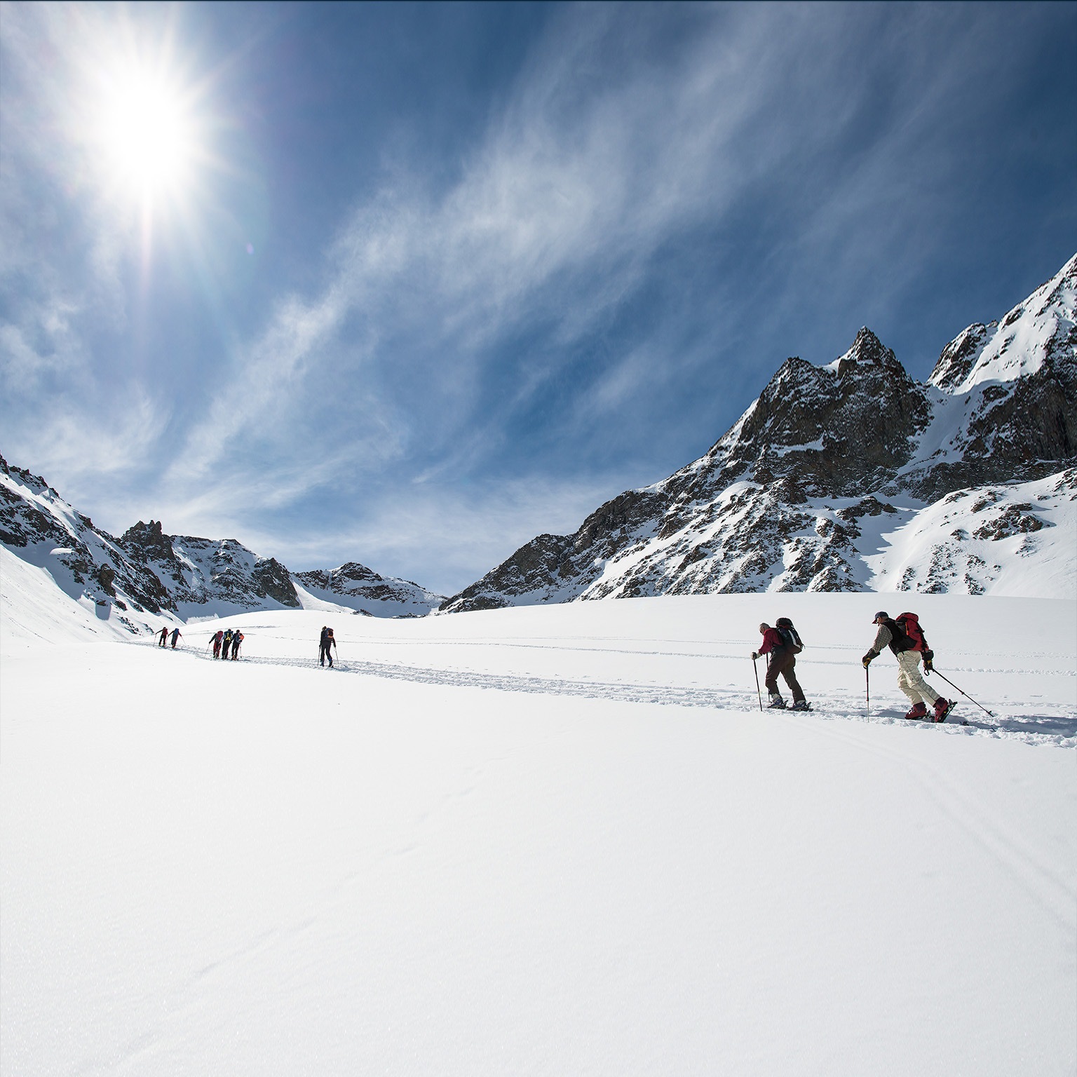 Group of ski mountaineers during a trip on the alps - stock photo