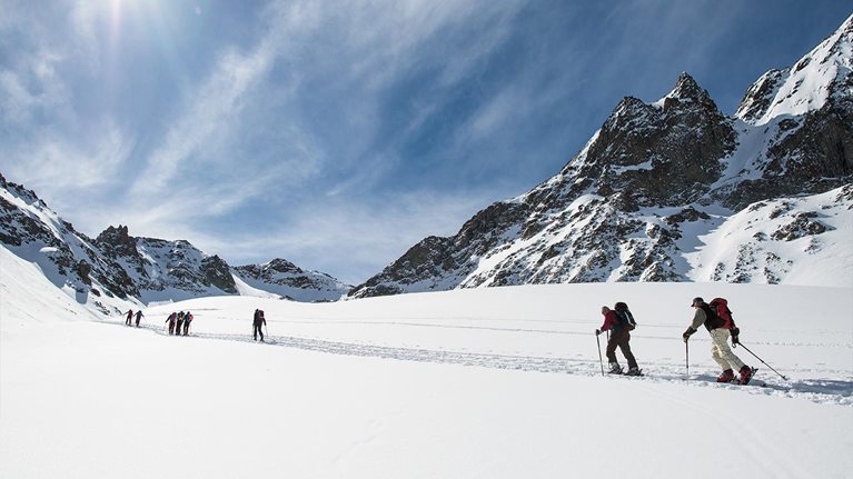 Group of ski mountaineers during a trip on the alps - stock photo