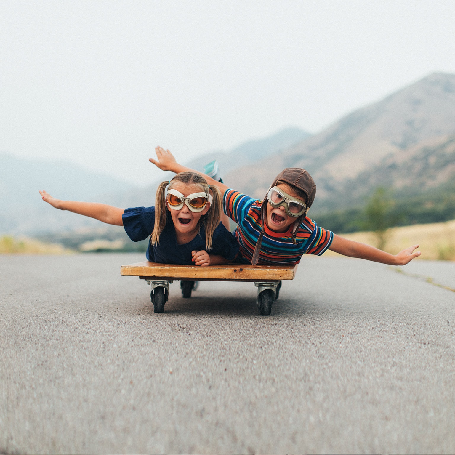 Young Kids Flying on a Press Cart - stock photo