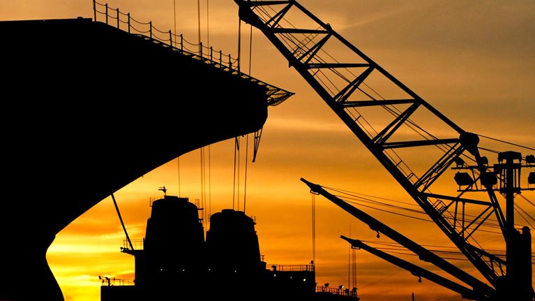 Silhouette of a ship and crane during sunset at the Philadelphia Navy Yard.