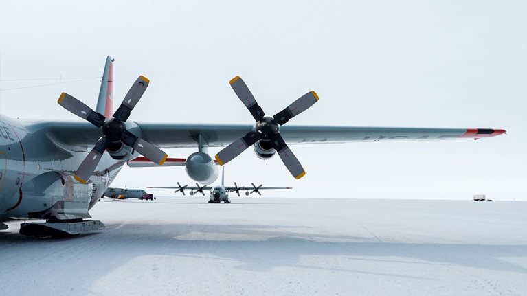 US Air force Hercules resting on skis on a sea ice tarmac. - stock photo