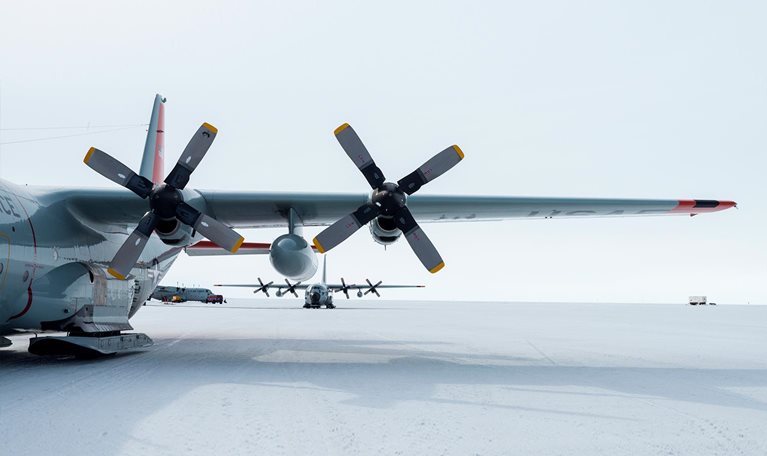 US Air force Hercules resting on skis on a sea ice tarmac. - stock photo