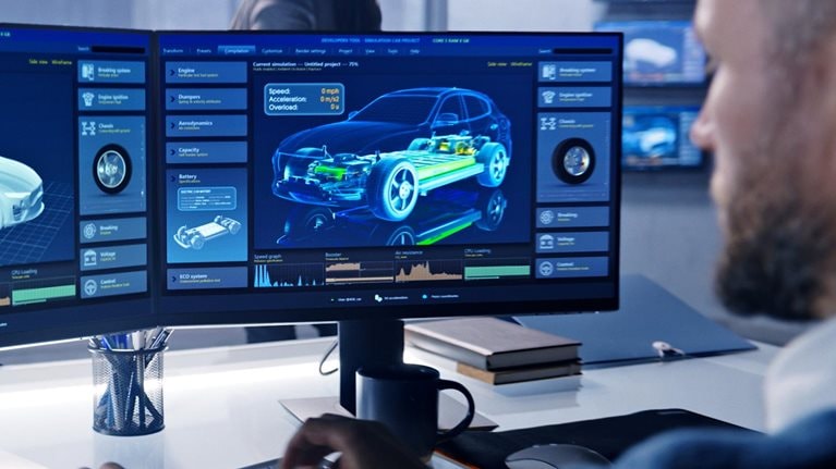 Engineers check aerodynamics of electric car on computer screen - stock photo