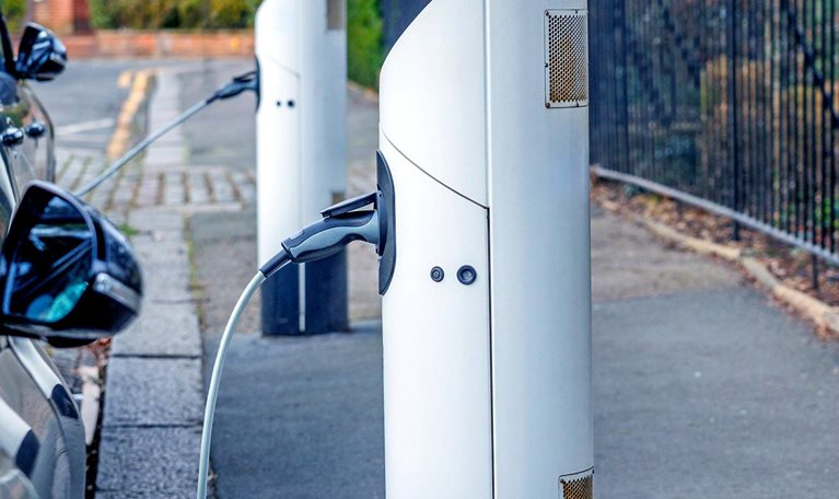 Electric cars standing in a row and charging at a public charger point
