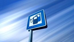 A road sign with an icon for an electric car charging station in Germany