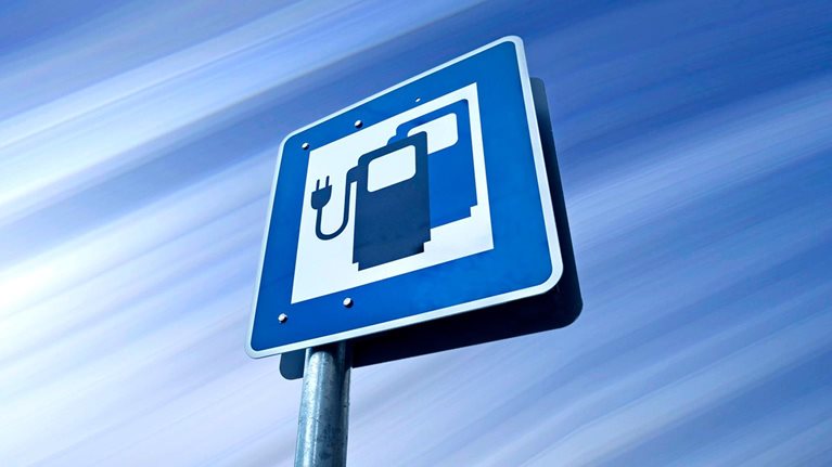 A road sign with an icon for an electric car charging station in Germany