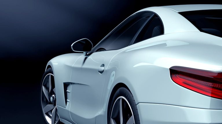 White sport car in a dark showroom