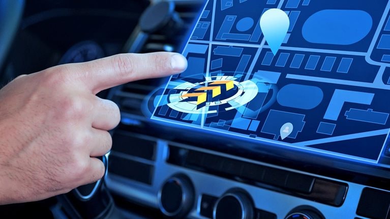 Closeup of a person using a futuristic navigation system while driving a car.