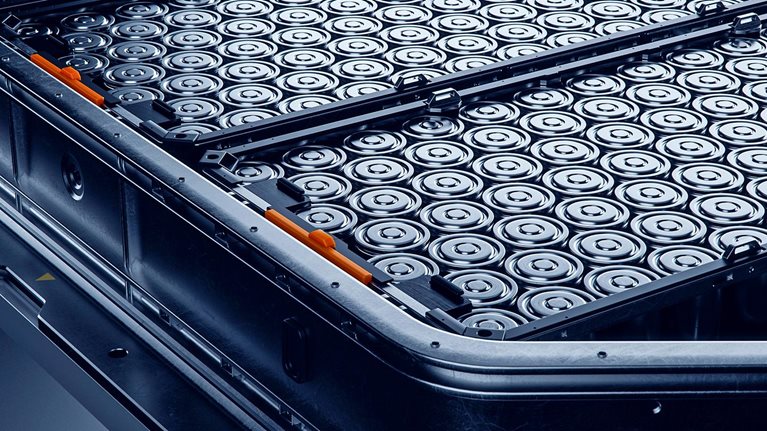 Close-up of High capacity EV Battery Pack with Orange Connectors Isolated on a Black Background.