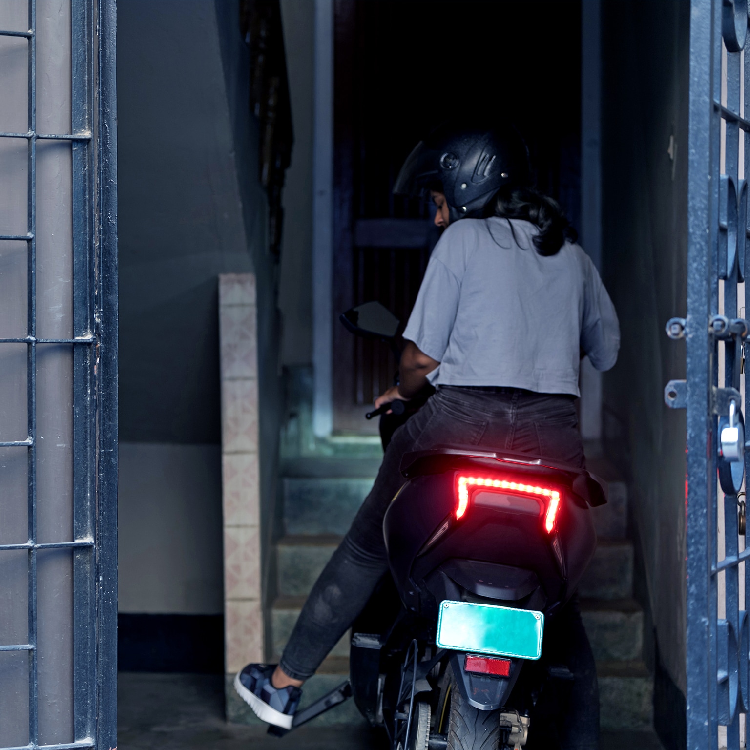 Young Woman parking her electric scooter. - stock photo