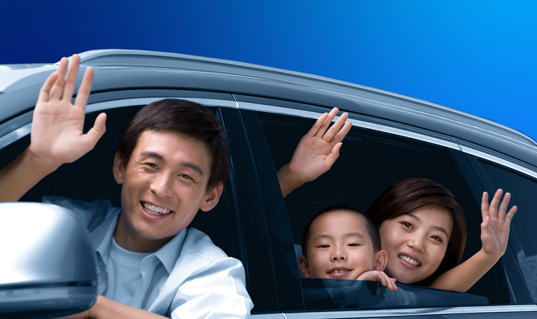 Family waving from a car