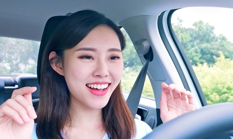 A woman behind the steering wheel of an autonomous self driving car