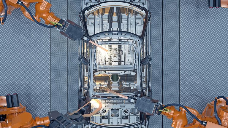 Digital generated image of robots welding a car body on production line