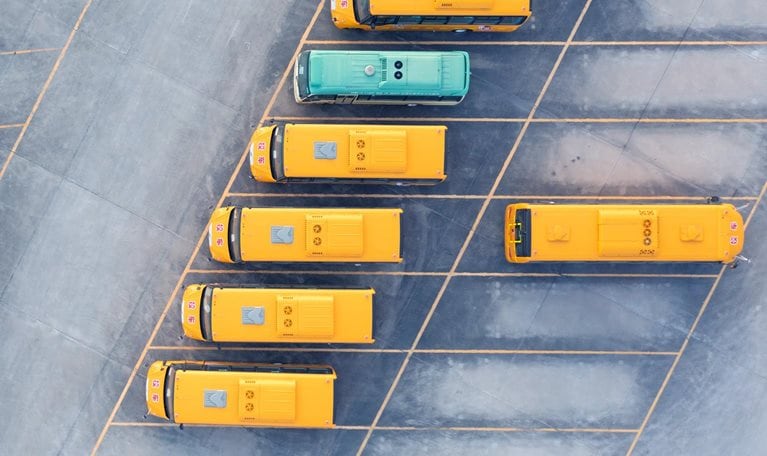 Aerial view of electric bus at factory parking lot.