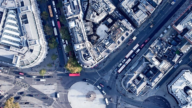 Directly above view of traffic circle amongst buildings, London, England, UK