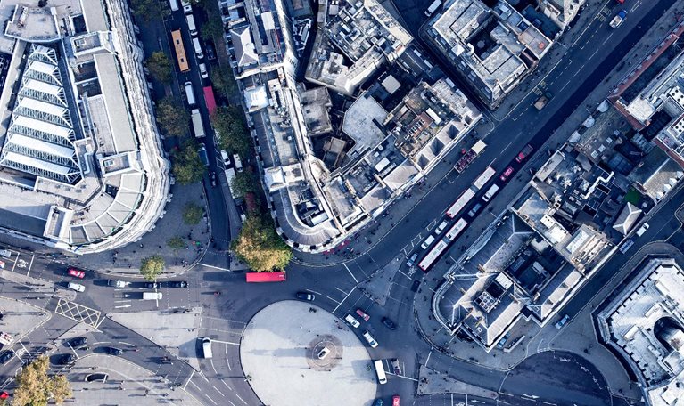Directly above view of traffic circle amongst buildings, London, England, UK