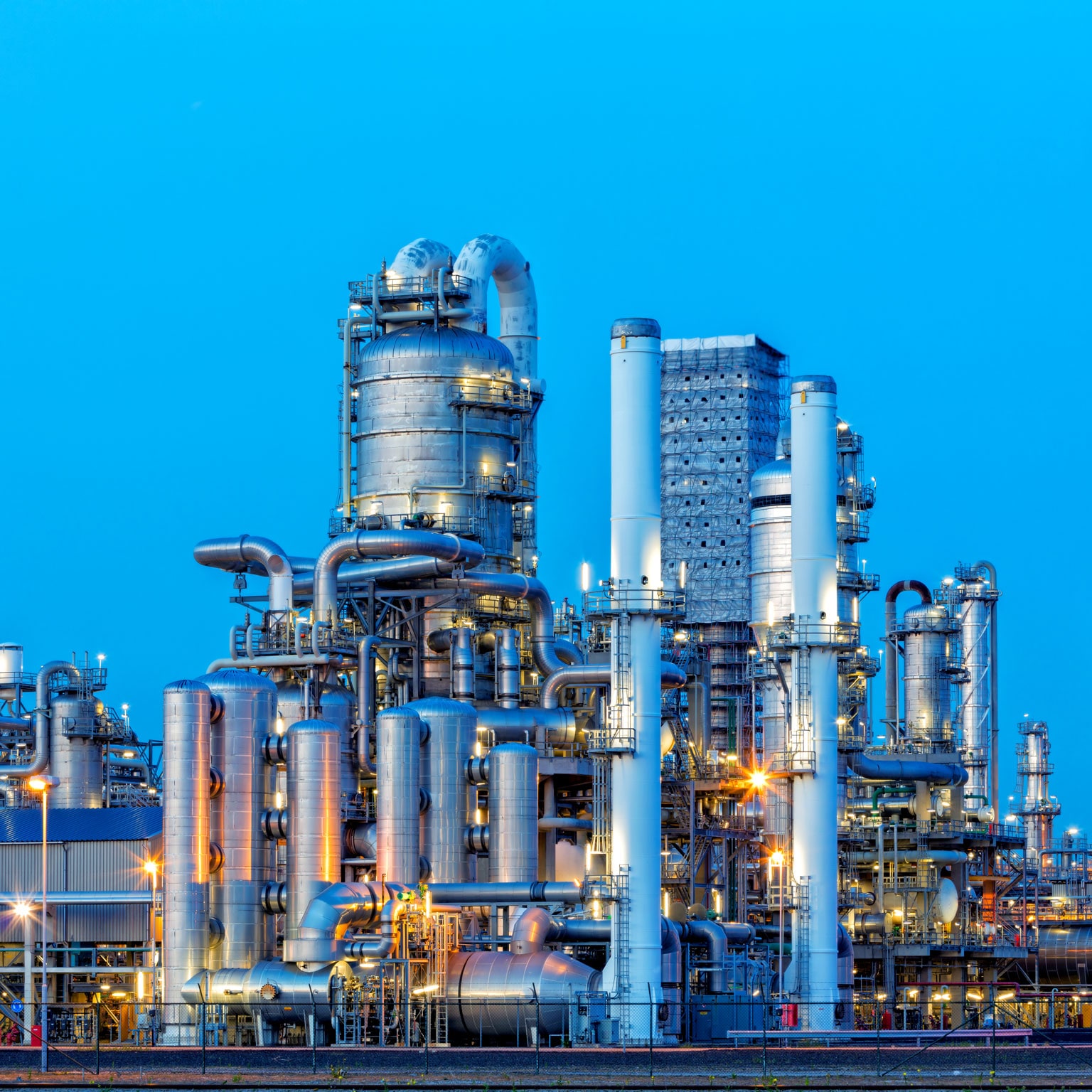 Petrochemical plant illuminated at dusk