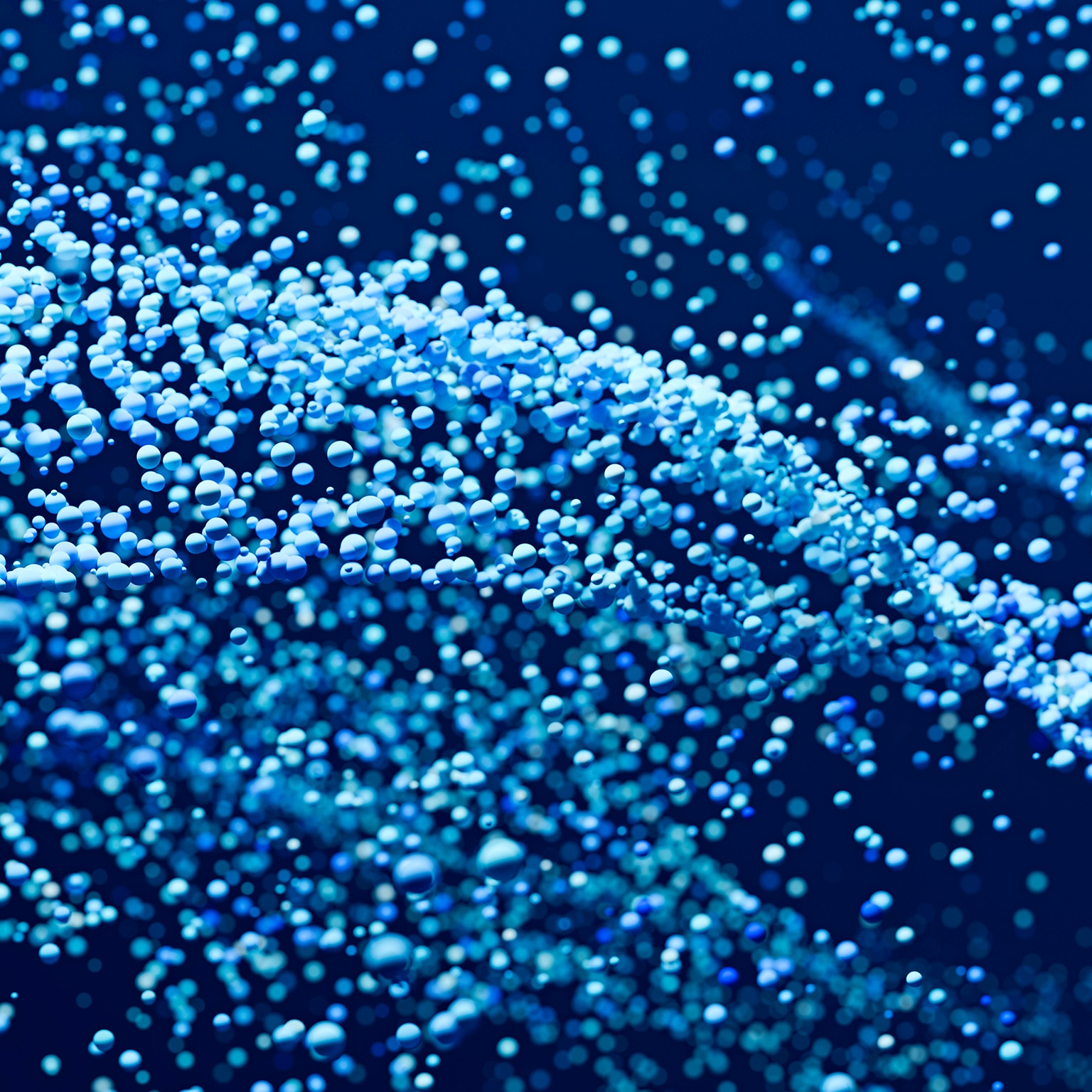 Abstract background with many blue and cyan spheres floating and flowing on a dark blue background, creating a sense of depth and motion