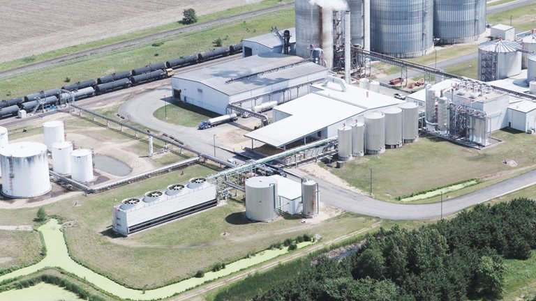 Aerial view of industrial buildings in fields.