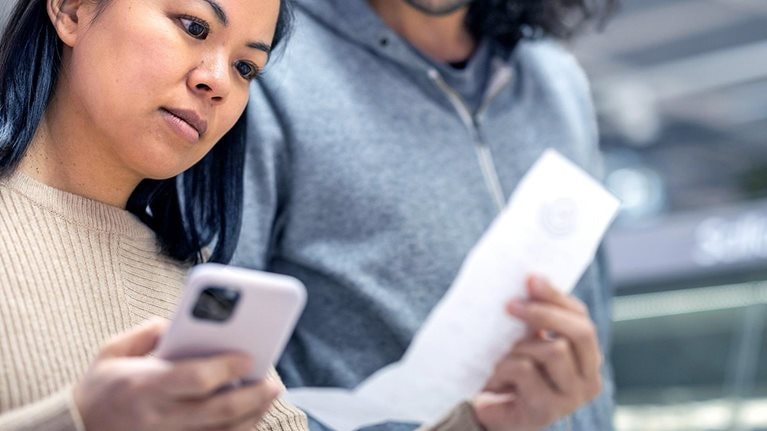 Young couple discussing over receipt at supermarket