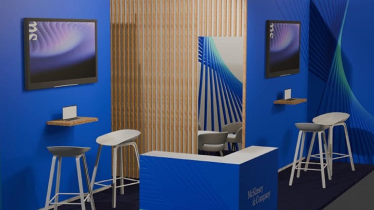 This image shows a modern corporate booth designed for a business event.