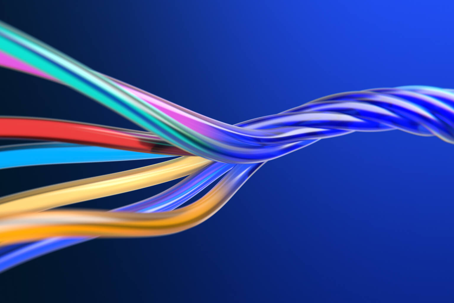 This digital graphic depicts glossy, multicolored cables intertwined in a spiral shape against a solid blue background. It is used to visualize complex network infrastructure, data cables, or AI transformation concepts.