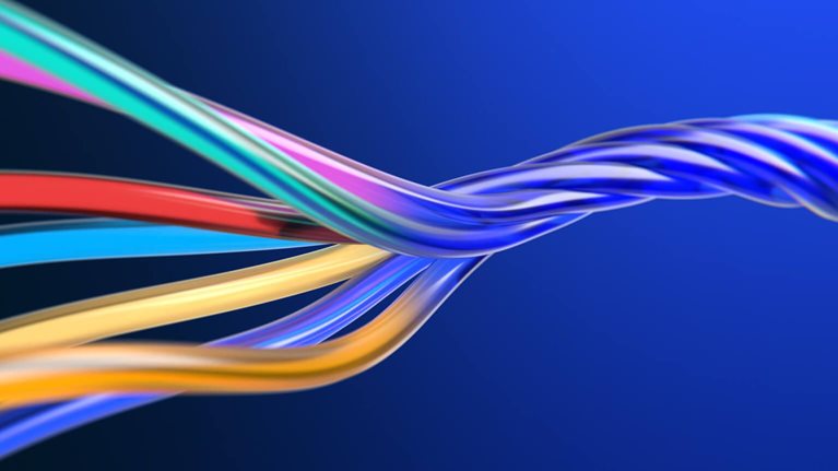 This digital graphic depicts glossy, multicolored cables intertwined in a spiral shape against a solid blue background. It is used to visualize complex network infrastructure, data cables, or AI transformation concepts.