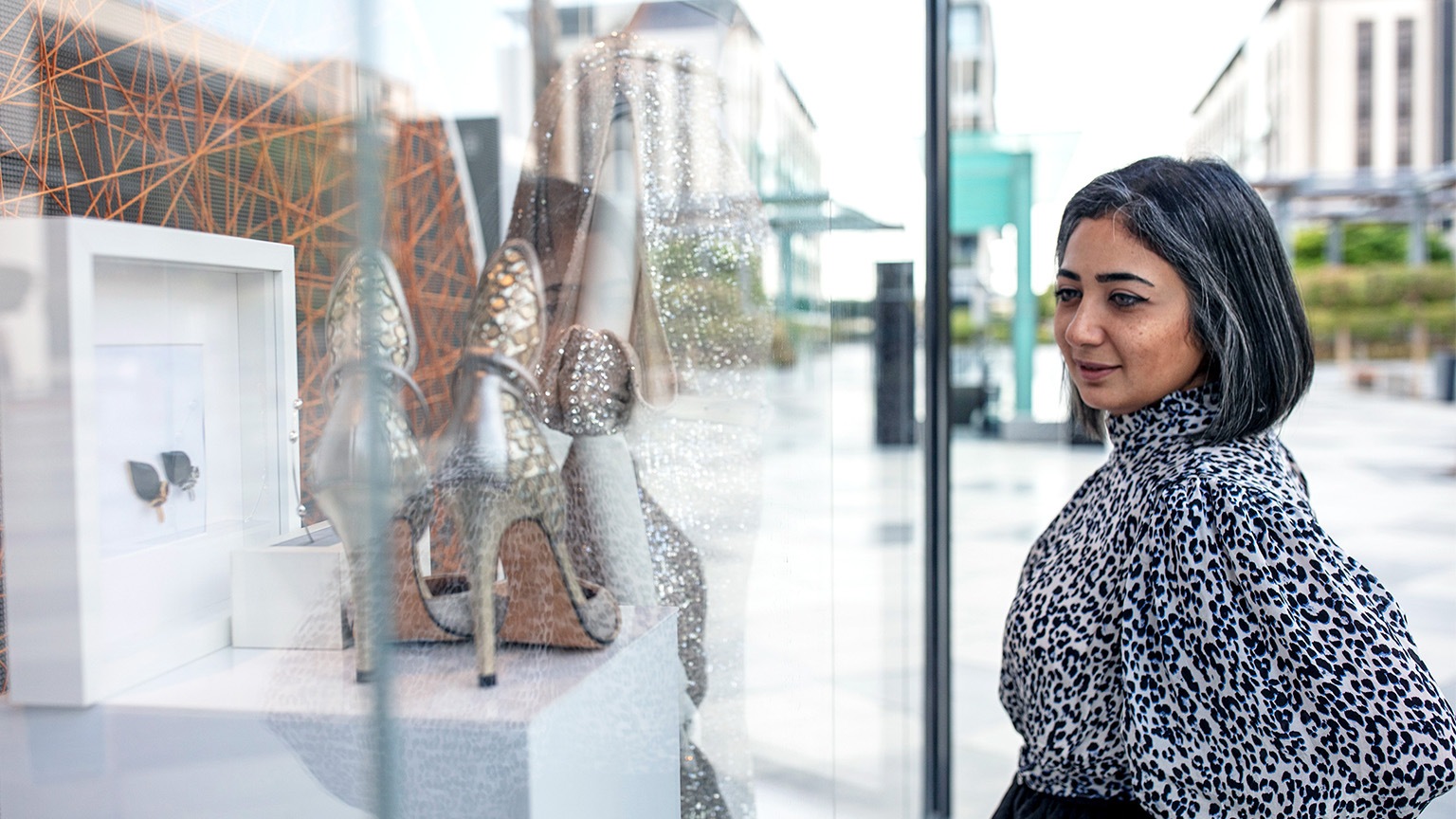 Middle Eastern woman window shopping