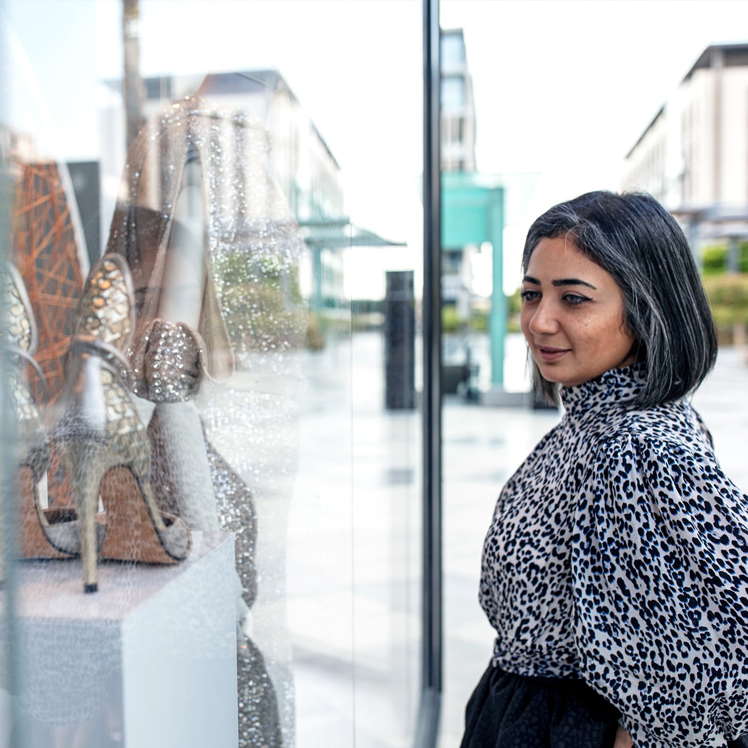 Middle Eastern woman window shopping