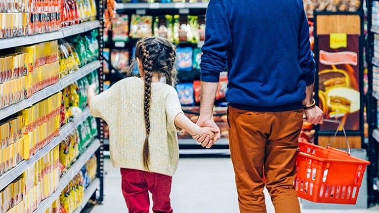 Man and child walking through department store aisles