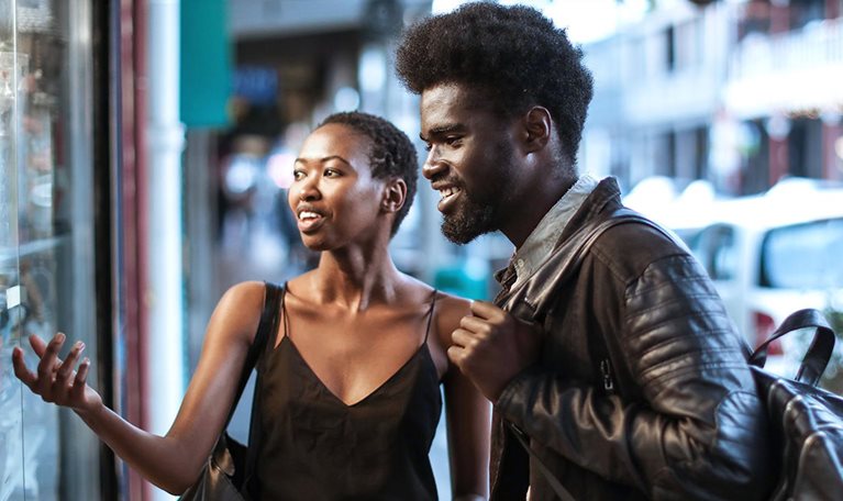 African couple window shopping