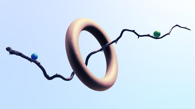 A twisty branch floating though a ring with 2 marbles balancing on each side. The branch subtly resembles a line graph with an upward trend.