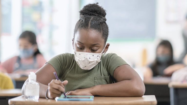 Student wearing mask at desk