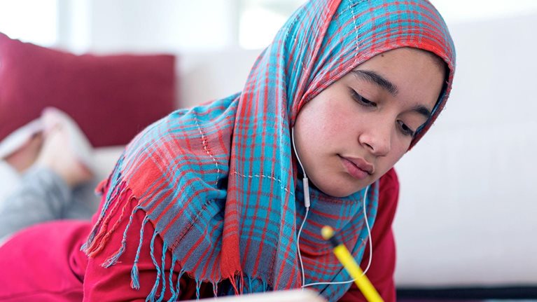 Muslim girl studying at home