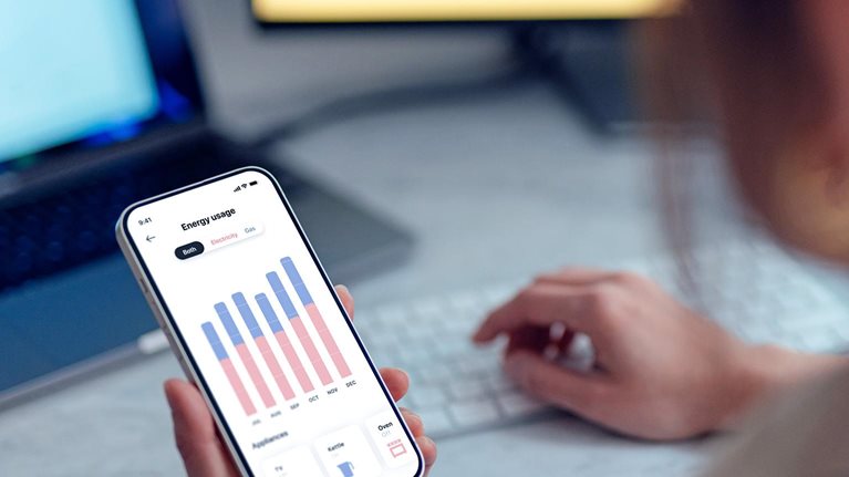 A young person pays the energy bill through an app on their phone