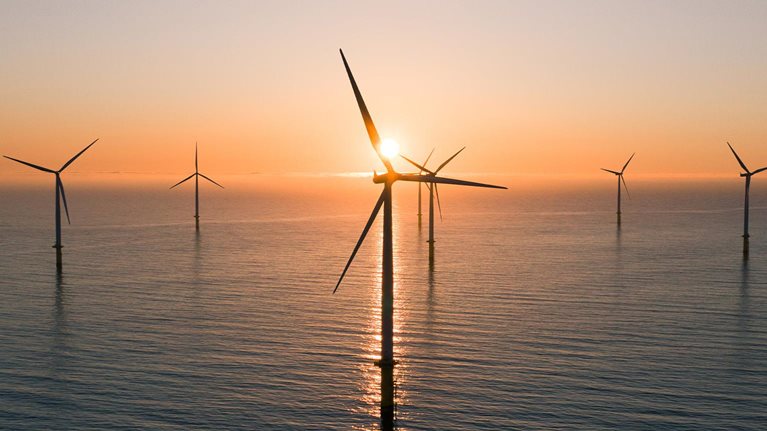 Offshore wind turbines at sunrise seen from an aerial point of view, Redcar, England, United Kingdom - stock photo