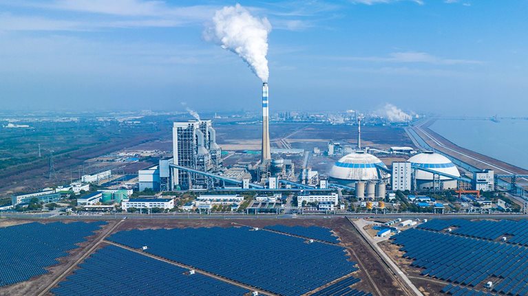 Aerial view of solar power station and coal fired power station: Clean energy and coal energy - stock photo