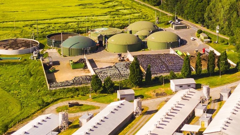 Aerial view of biogas plant near farm in countryside - stock photo