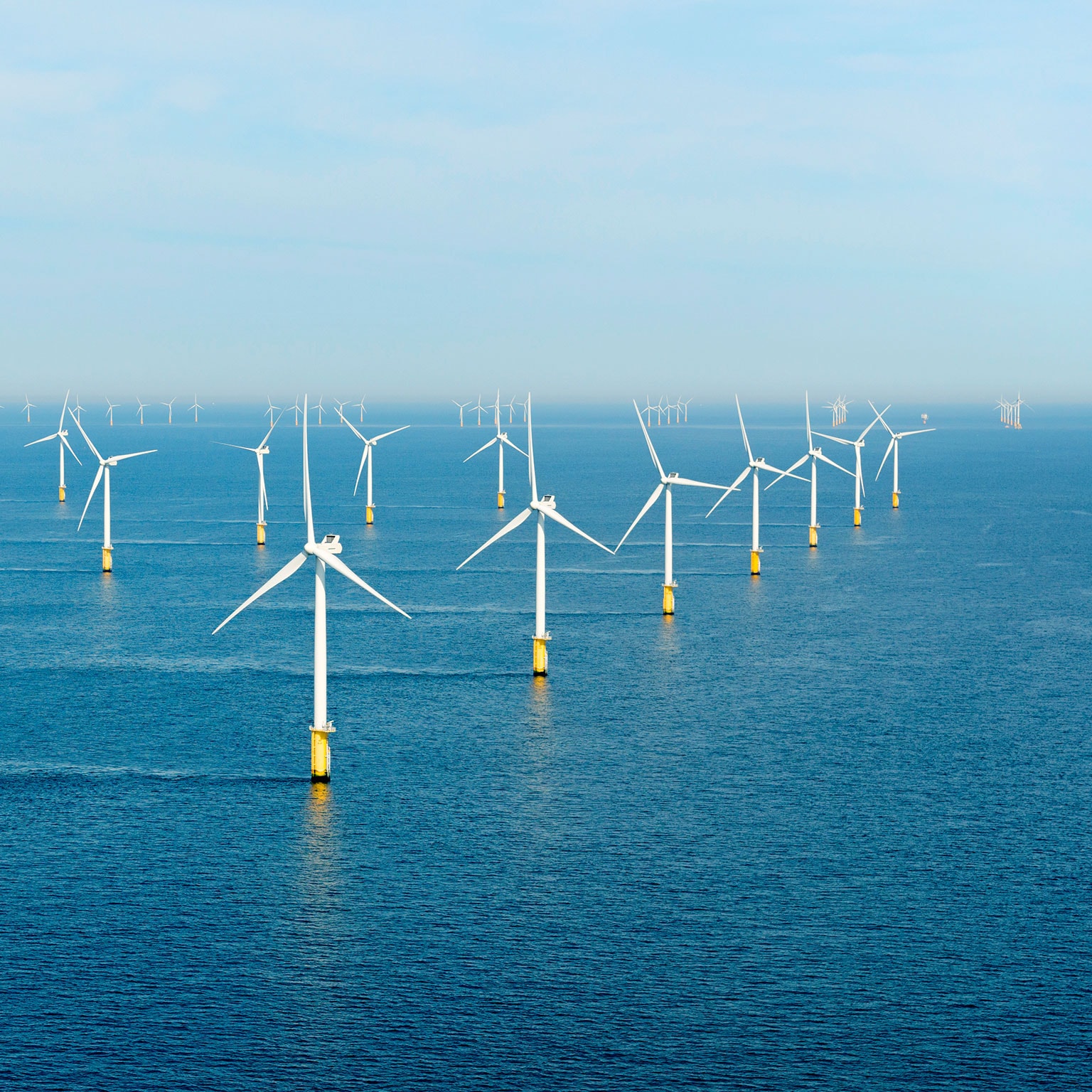 Windmills standing in a waterbody.
