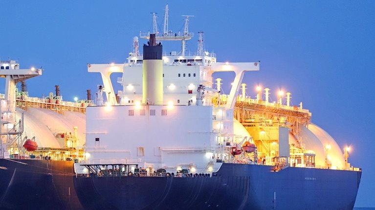 A liquified natural gas tanker supplying gas to a floating storage unit ship (LNG FSU) - stock photo