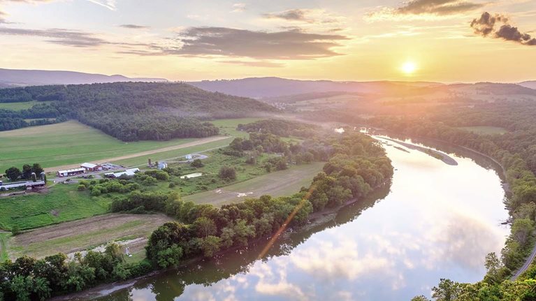 The sun sets over the Susquehanna River and the Terry Township's rolling farmland in northern Pennsylvania.